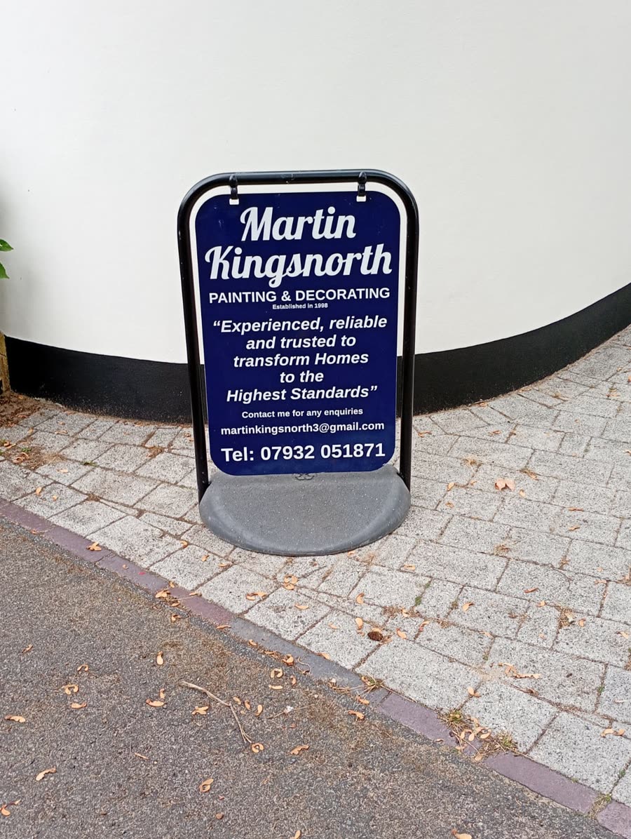 Martin Kingsnorth Painting and Decorating A-board in front of a white painted rendered wall