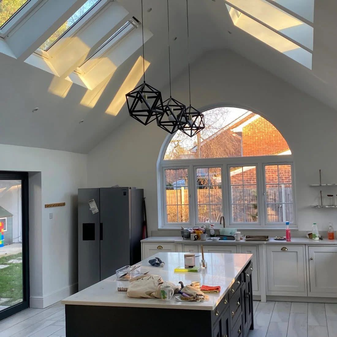 Vaulted kitchen extension with white walls and roof windows