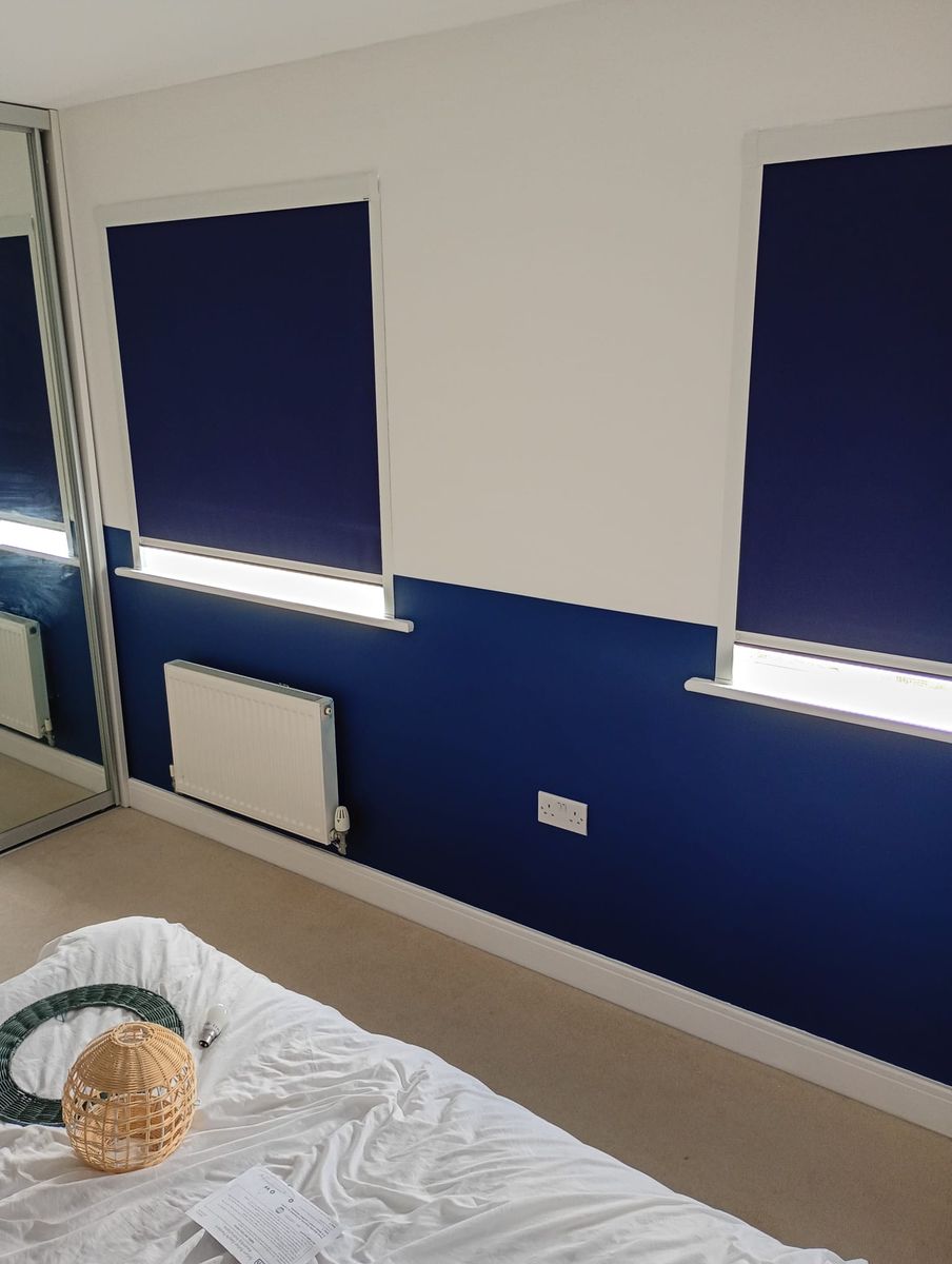 Bedroom with navy lower walls and white upper walls